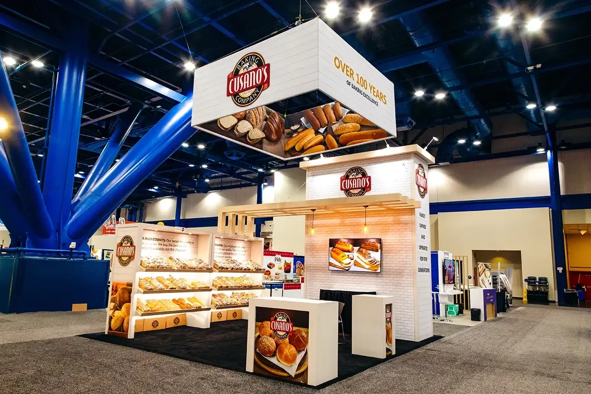 Cusano’s Baking Company 20x20 trade show booth with a hanging sign and bread displays