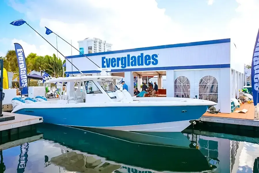 Blue and white boat docked beside the Everglades showroom