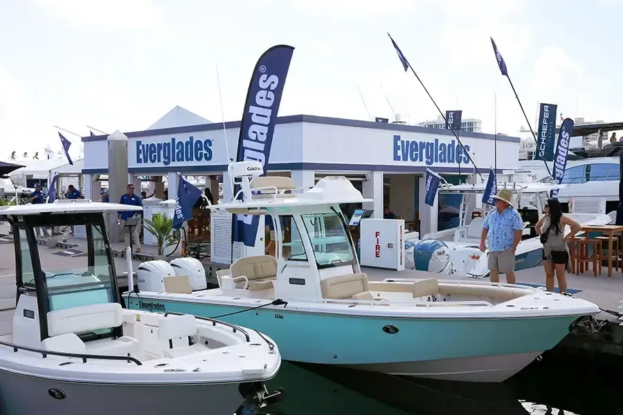 Everglades boats and booth with promotional flags at the boat show