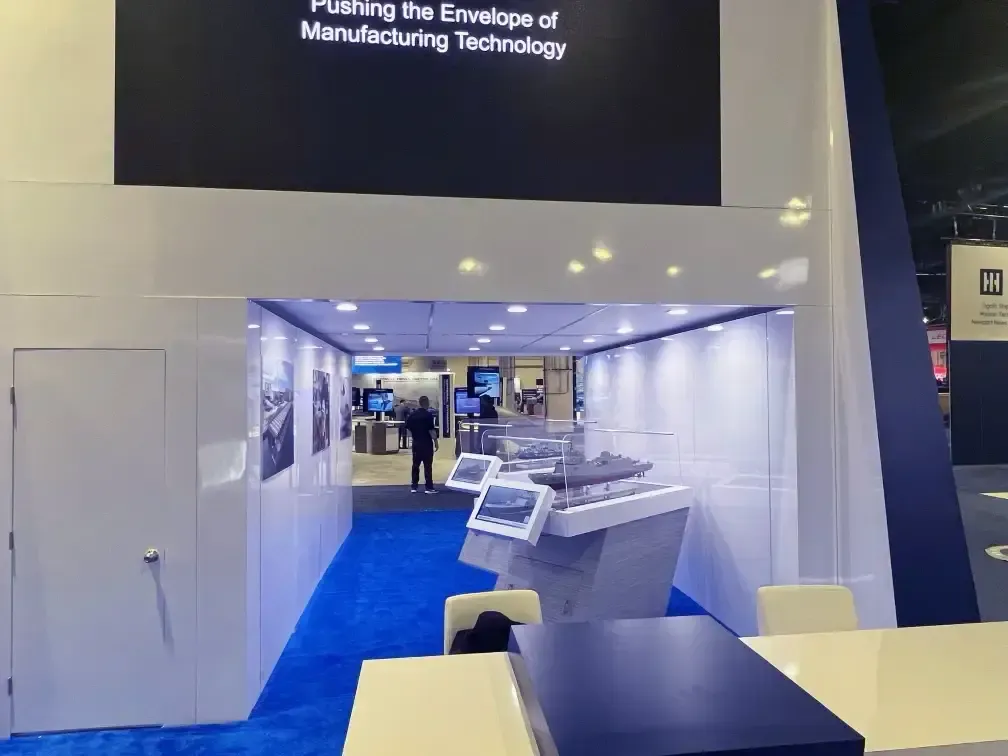 Fincantieri Marine Group exhibition booth featuring ship models