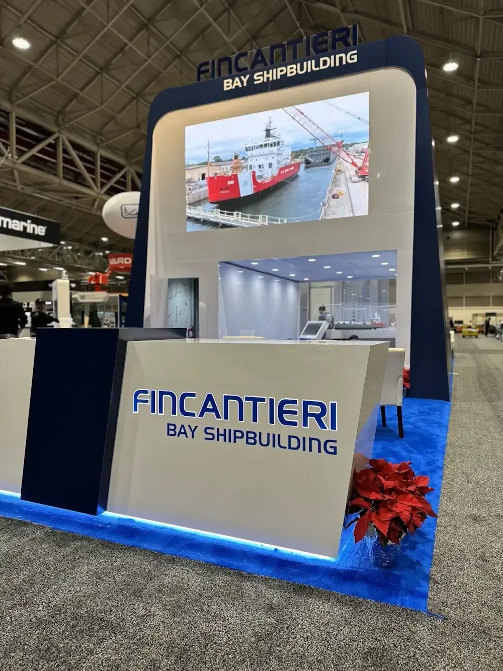 Fincantieri branded tower with a large video screen and reception desk
