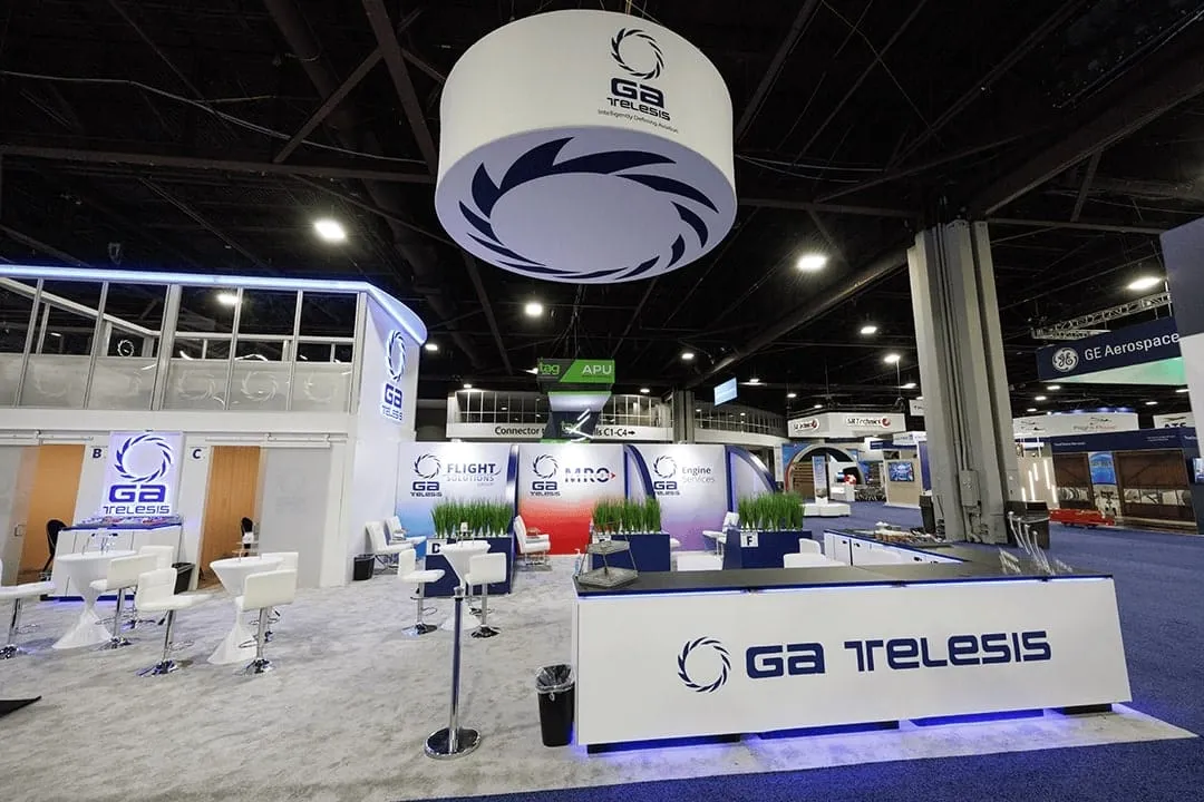GA Telesis exhibit at MRO Americas with a hanging ring sign and branded counters