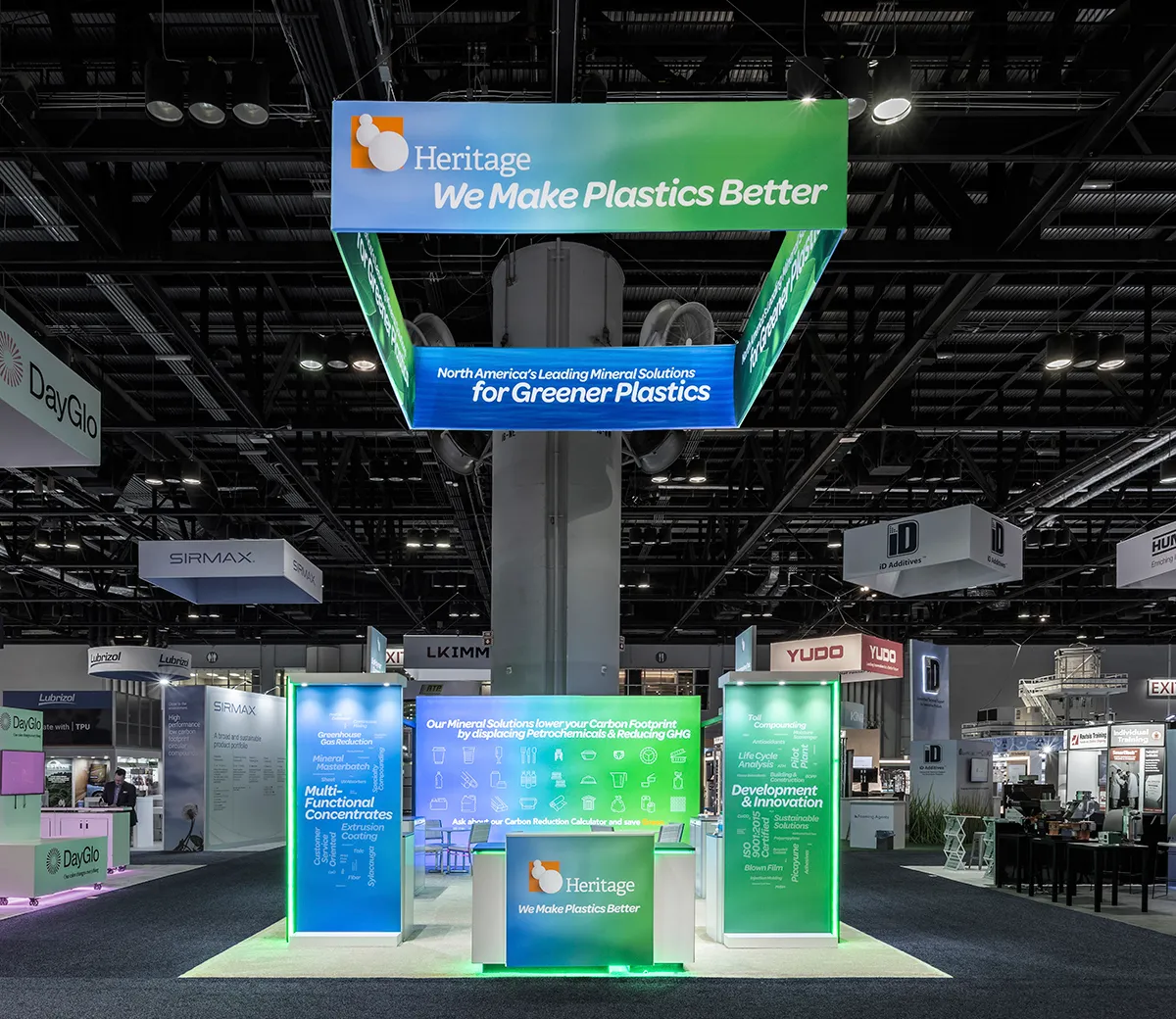Front of the Heritage Plastics booth with its overhead sign wrapped around the column