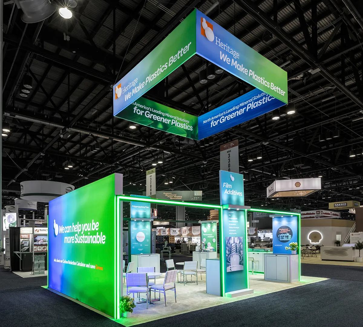 Heritage Plastics booth seen from the aisle with green lighting