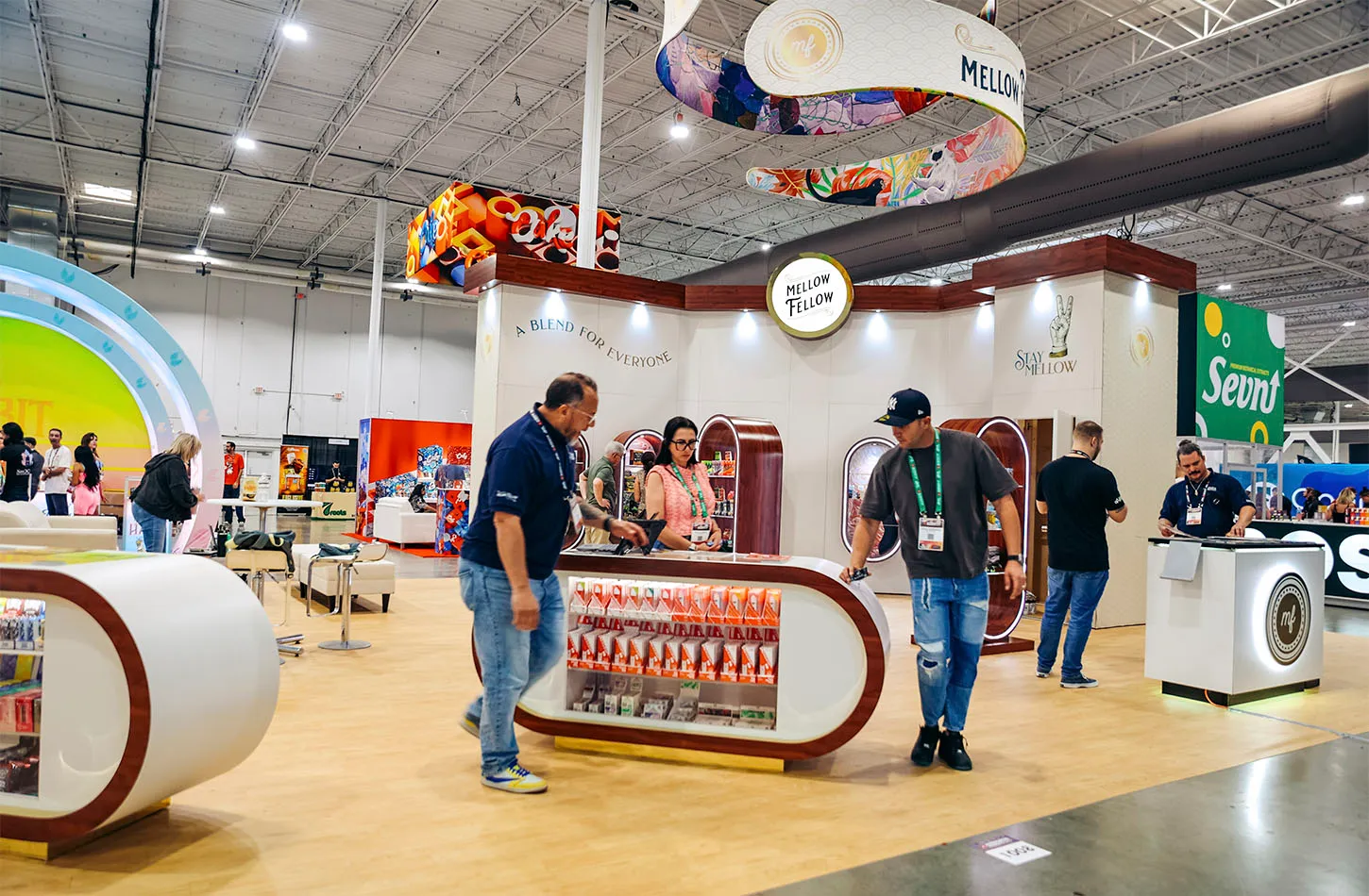 Attendees browsing product displays at the Mellow Fellow exhibit