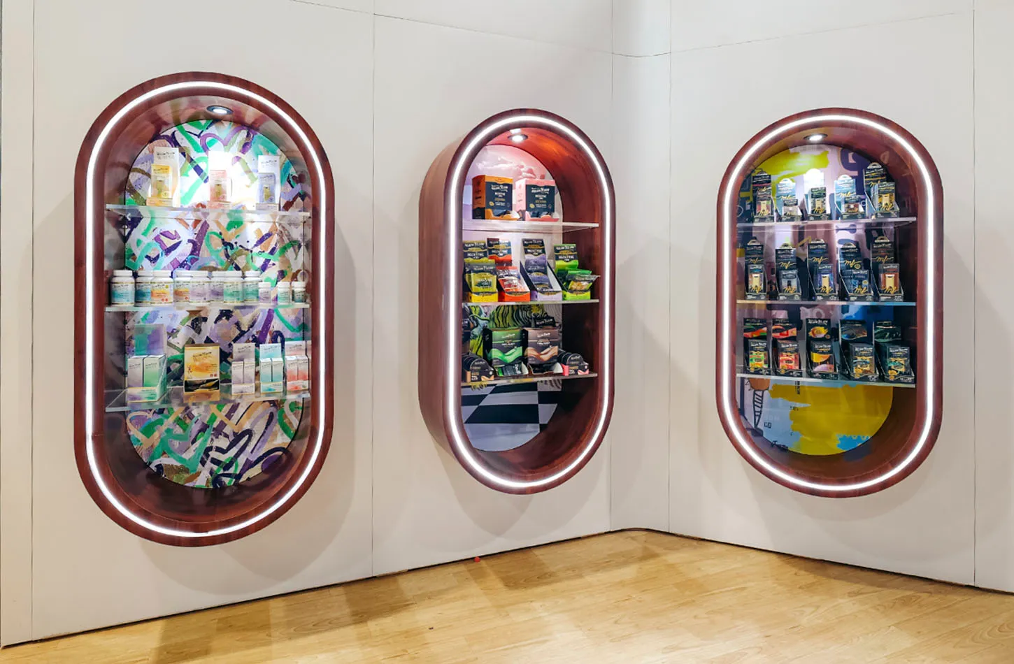 Three walnut-framed oval niches stocked with Mellow Fellow products