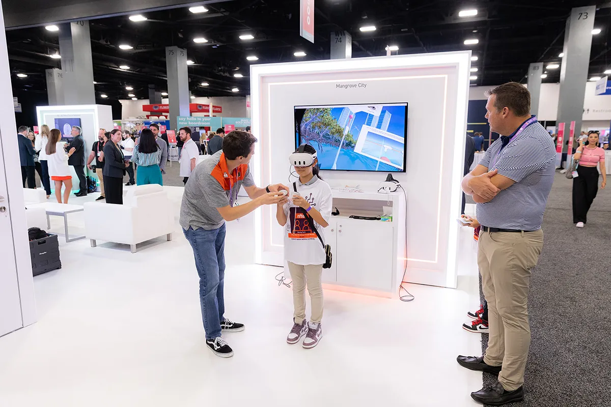 Visitors trying an interactive demo at the University of Miami exhibit