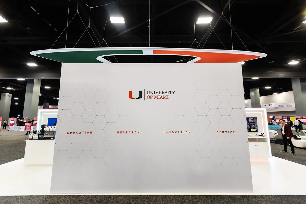 University of Miami back wall with the U logo and research themes