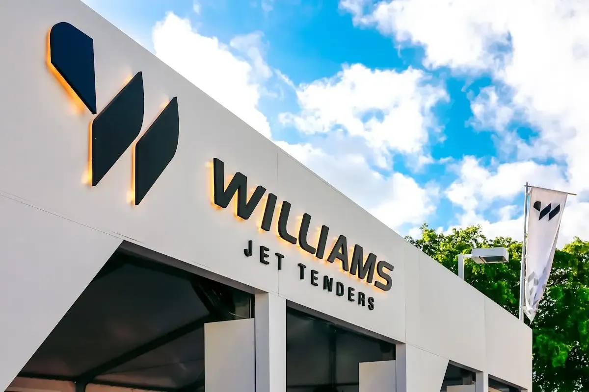 Williams Jet Tenders exhibit with a backlit logo wall