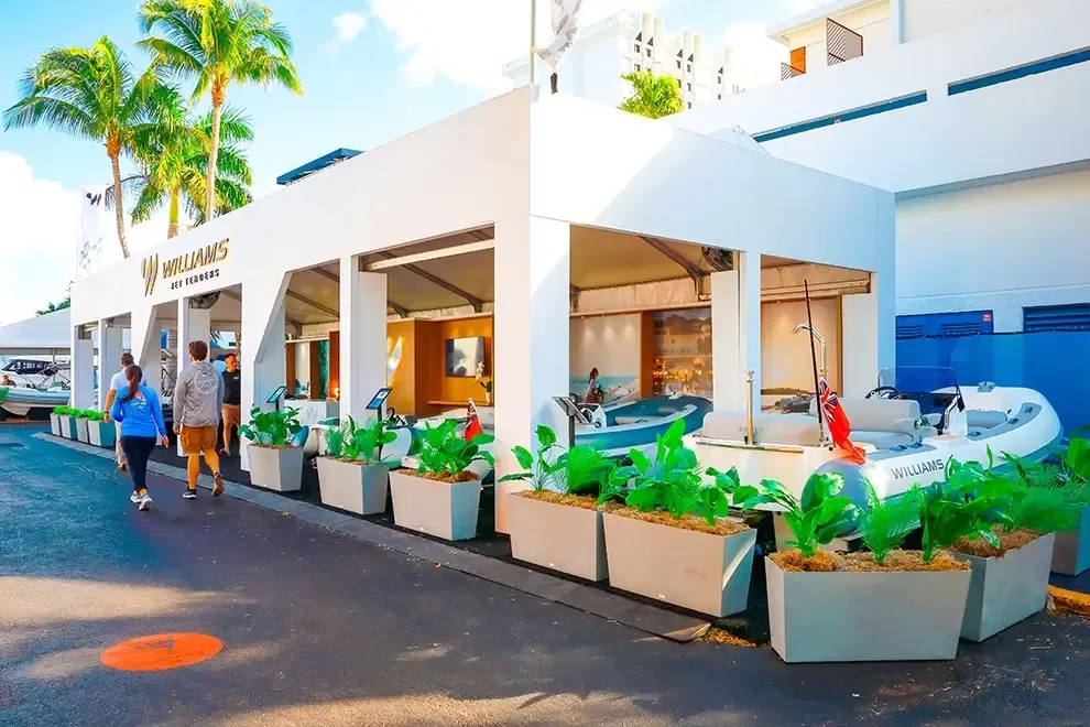 Outdoor Williams Jet Tenders booth with boats and planter boxes
