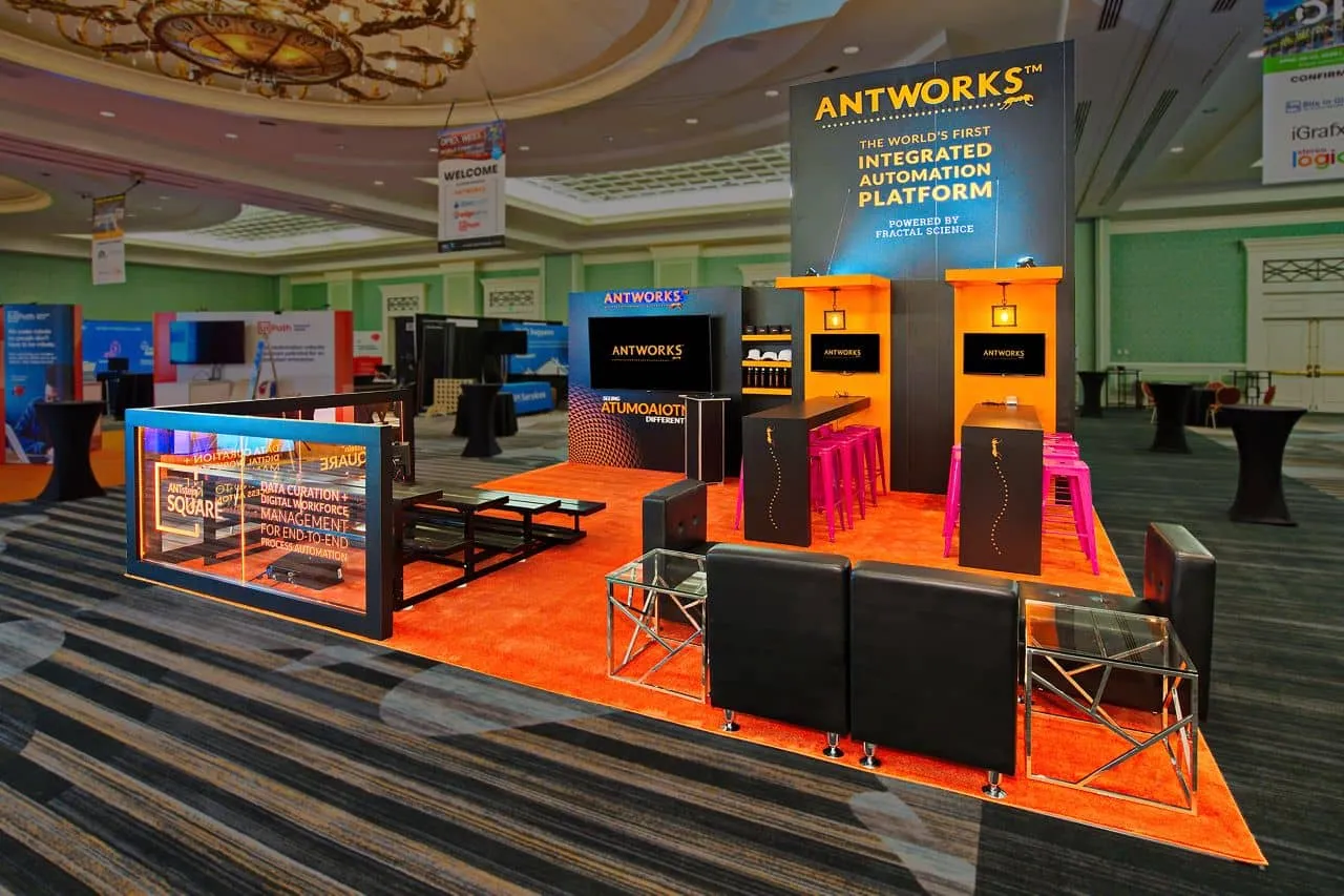 Vibrant orange-carpeted trade show booth designed for AntWorks